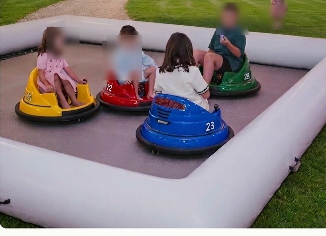 Inflatable bumper car arena with four colorful kids' bumper cars in yellow, red, blue, and green